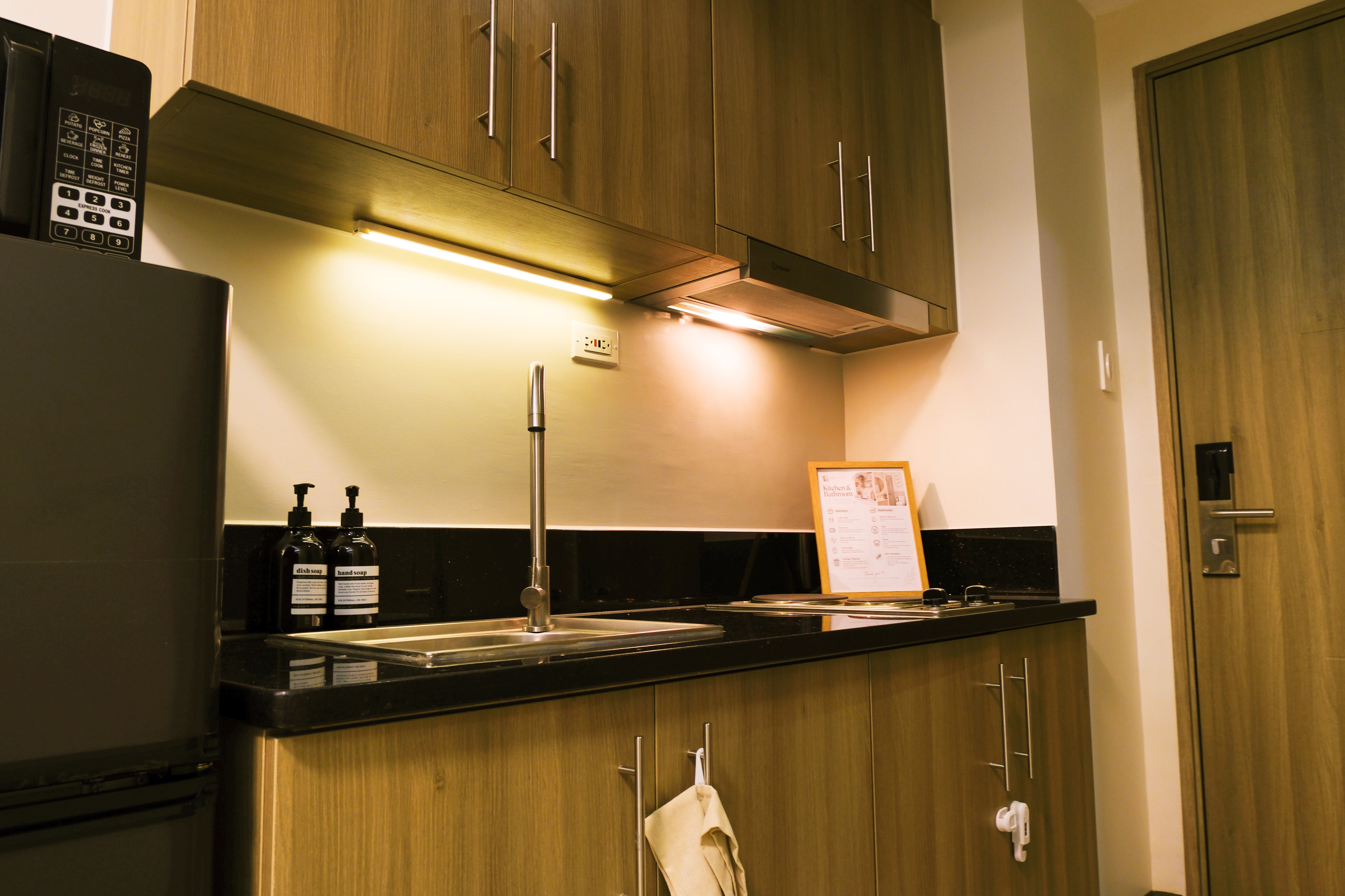 Modern kitchen with wood cabinets and black countertop