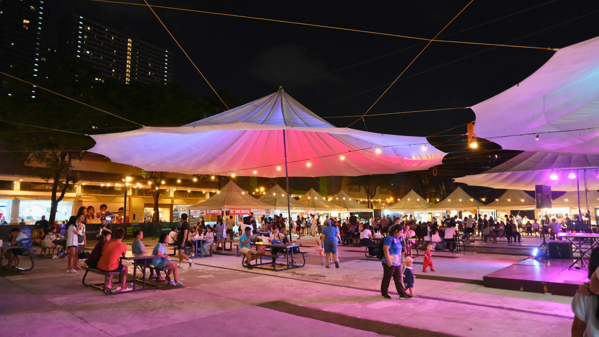 Outdoor night market with illuminated tents
