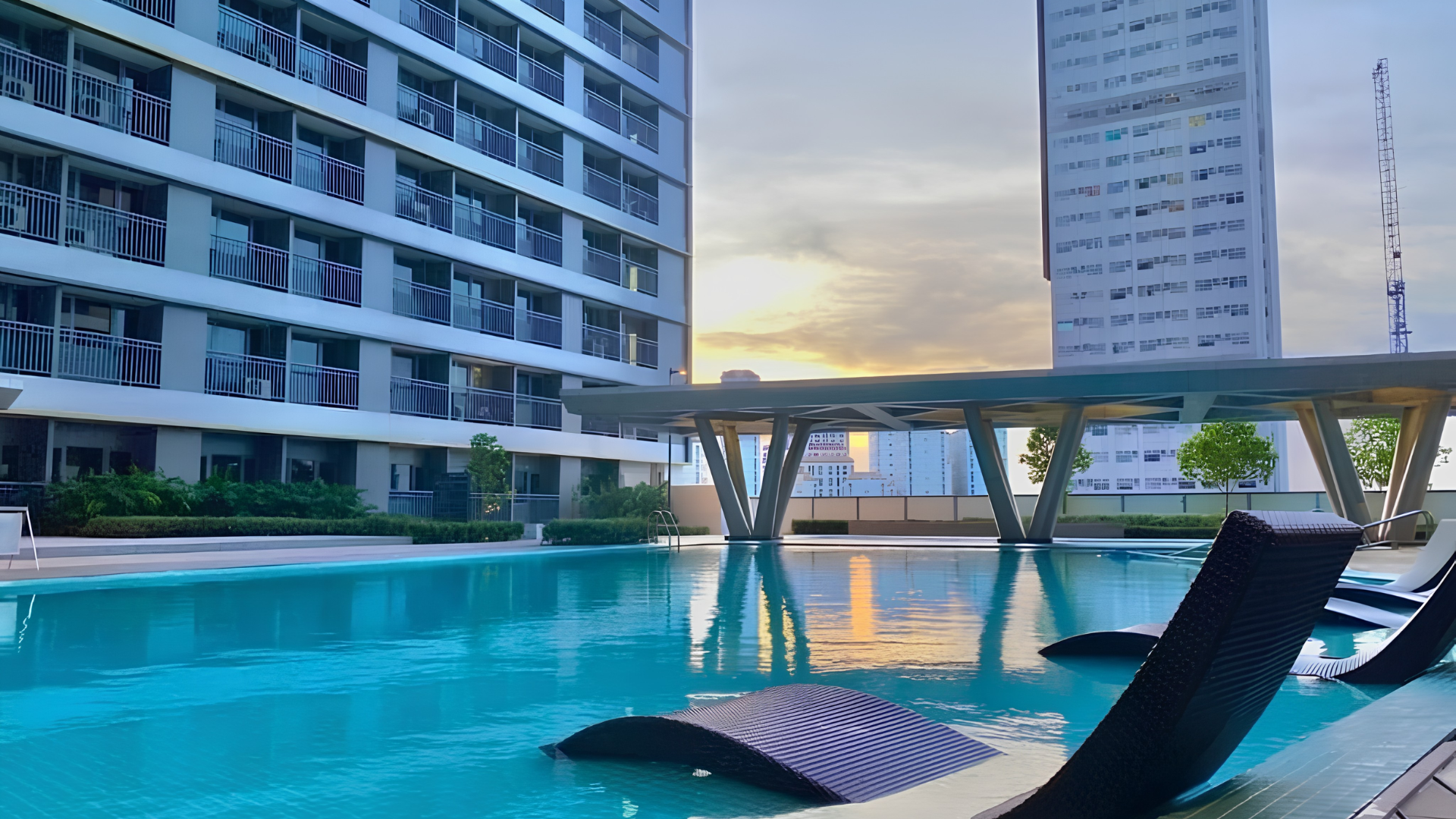 Rooftop pool with sunset reflection at Fame Residences