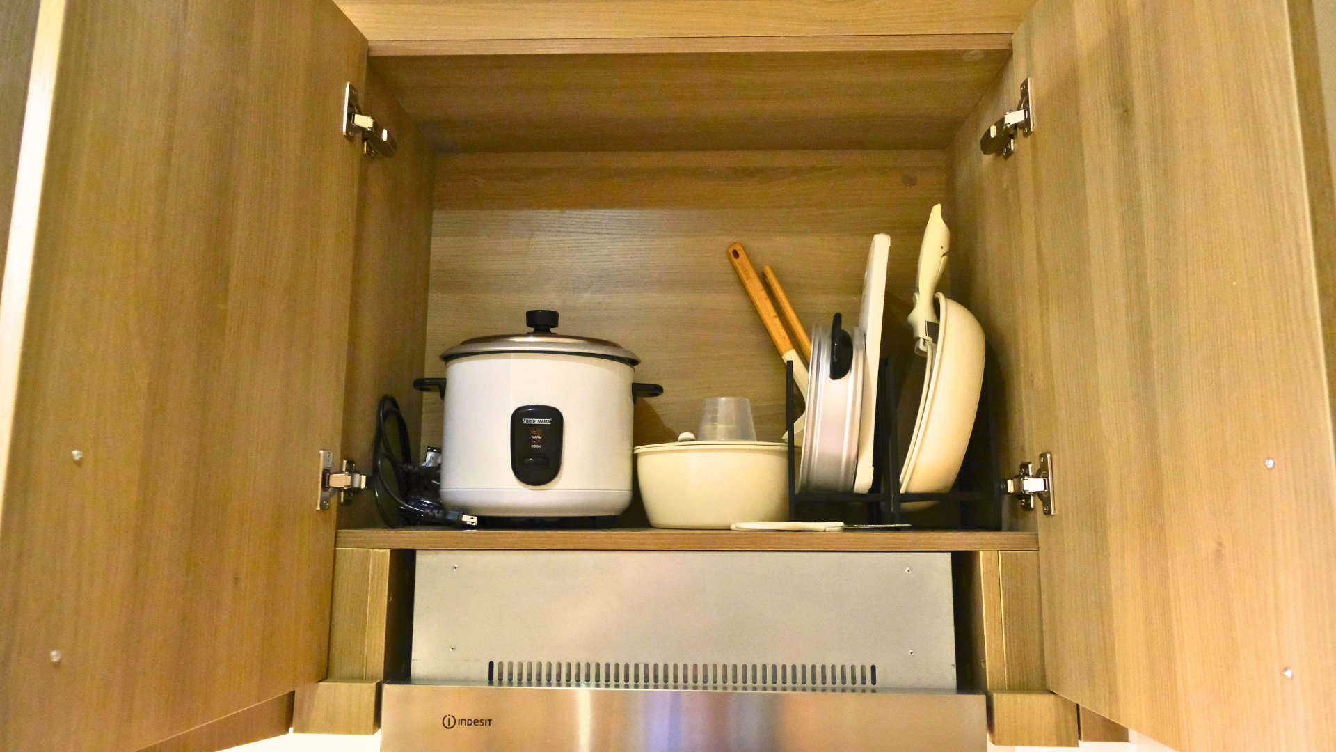 Organized kitchen cabinet with cooking appliances